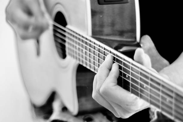 istock Focus on hands playing acoustic guitar 1272533658
