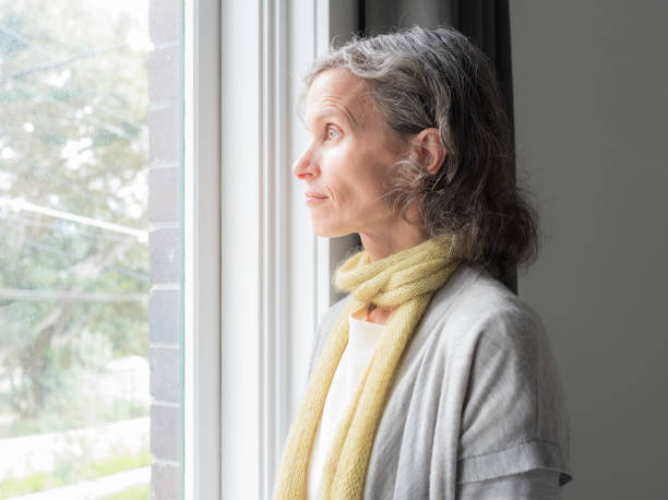 istock Profile of middle aged woman next to window 1272535561