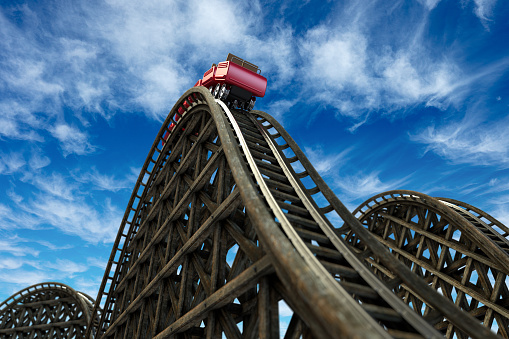 close-up image of a rollercoaster track and the cloudy sky