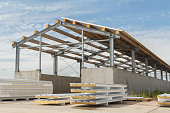 Metal frame of the building with a sandwich panel of insulation on the wall. Construction of a new industrial building. Modern Insulation of the walls of the building panels of insulation.