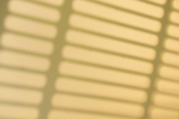 Shadow overlay effect. Shadows of window frames, bars and lines on the wall in sunlight. Soft sunshine