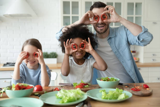istock Laughing multiracial family making funny faces in kitchen. 1272542137