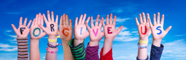 istock Children Hands Building Word Forgive Us, Blue Sky 1272542914