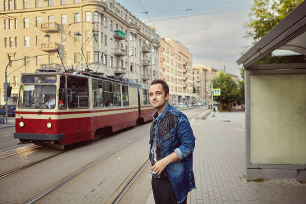 istock Man is standing near public transport stop. 1272544216