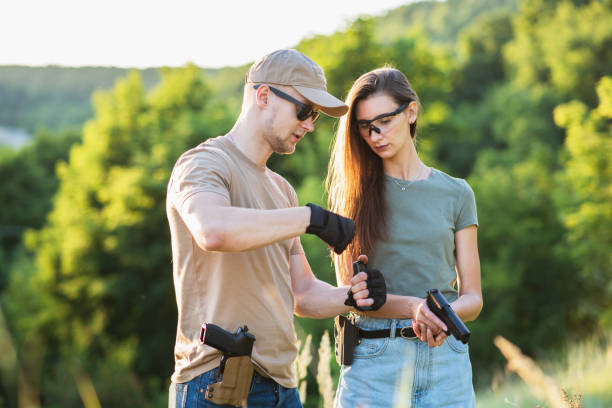 istock A girl learns to shoot a pistol with an instructor at the training ground 1272546209