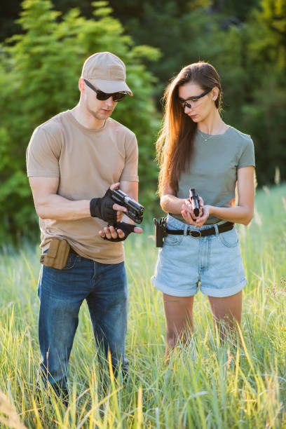 istock A girl learns to shoot a pistol with an instructor at the training ground 1272546401