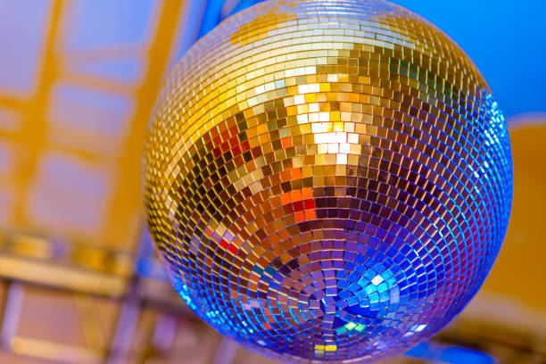istock Big disco ball on a colored background in a nightclub 1272548952