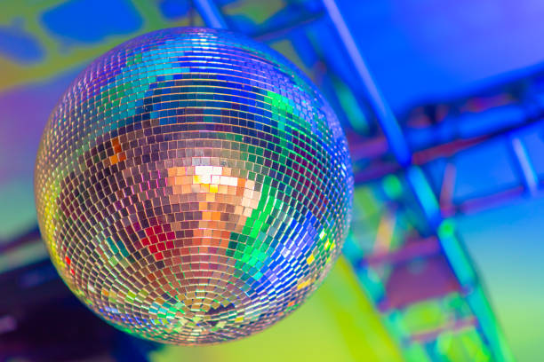 istock Big disco ball on a colored background in a nightclub 1272549014