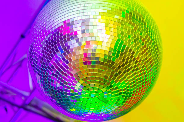 Big disco ball on a colored background in a nightclub