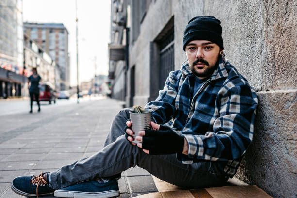 istock Homeless man sitting and begging for help 1272551080