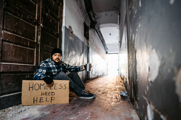 istock Homeless man sitting and begging for help 1272551123