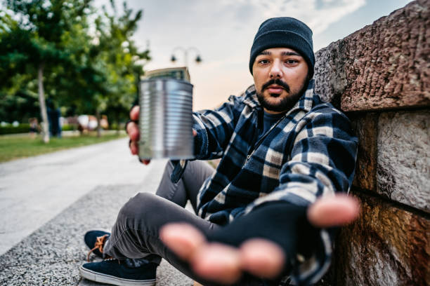 istock Homeless man sitting and begging for help 1272551260