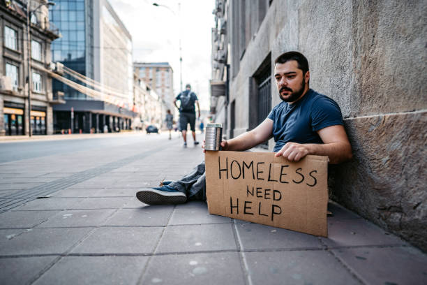 istock Homeless man sitting and begging for help 1272551303
