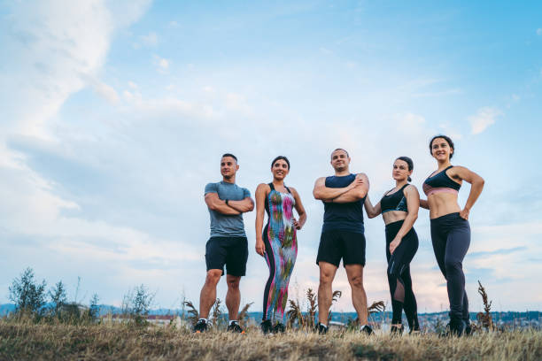 istock Fitness group on meadow above city 1272551707