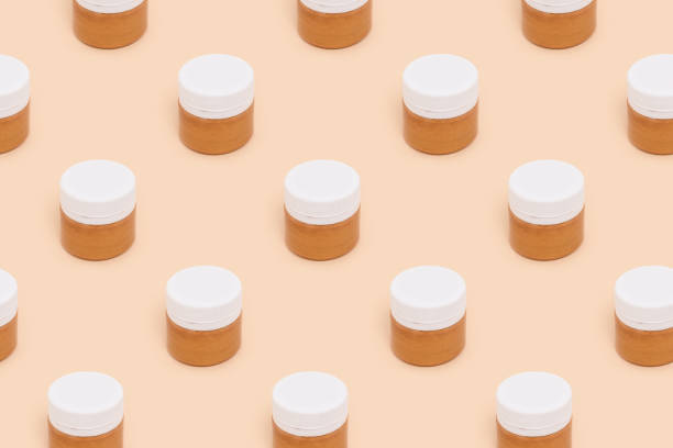 istock Jars of golden paint pattern on a beige background. 1272551899