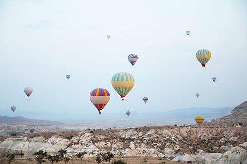 Hot air balloons flying over the valley at Cappadocia ,Travel destination in Turkey