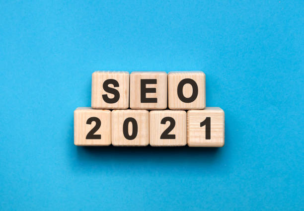 SEO - text concept on wooden cubes with gradient blue background