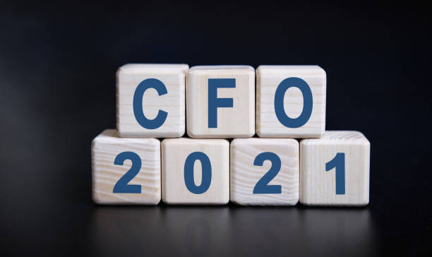 istock CFO 2021 text on wooden cubes on a black background with reflection. 1272552852