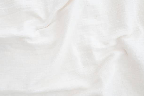 istock Fabric backdrop White linen canvas crumpled natural cotton fabric Natural linen top view  background  Organic Eco textiles White Fabric texture 1272554111