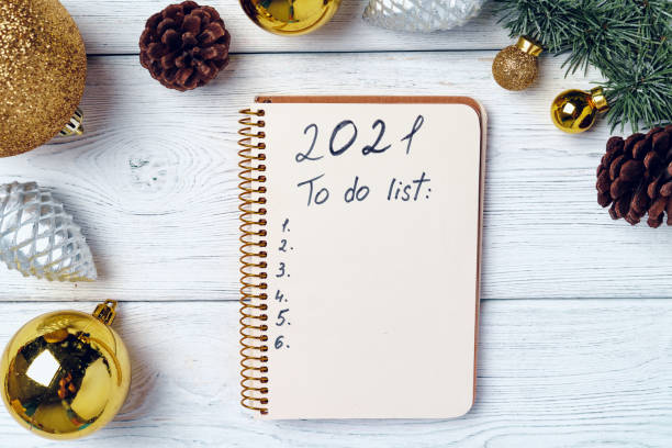 istock Open notepad for to do list with festive decorations on wooden surface 1272554675