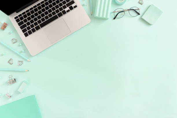 istock Border frame made of laptop and stationery on the mint table 1272554781
