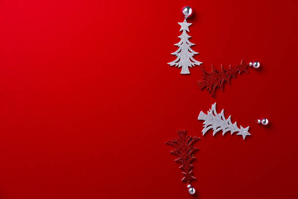istock Red background with carved wooden Christmas trees 1272555653