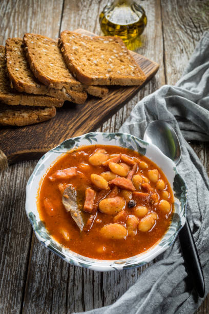 istock Beans with tomato sauce, bacon and sausage. 1272556001