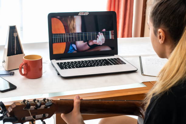 istock Little girl studying guitar lessons at home 1272556977