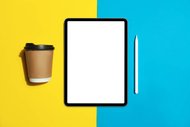 istock Tablet with white screen on eyllow color background with pencil 1272557378
