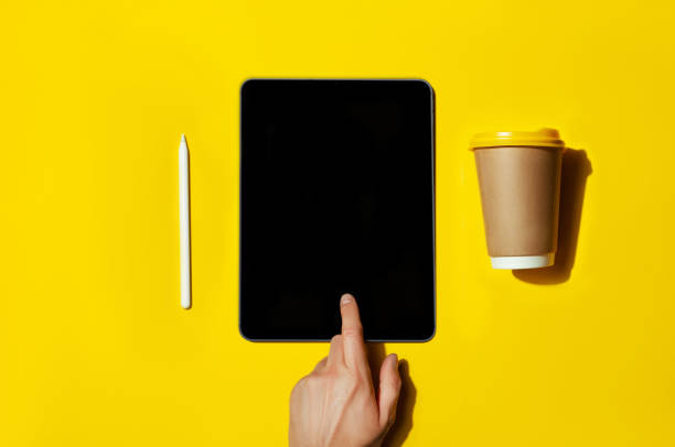 Tablet with white screen on eyllow color background with pencil