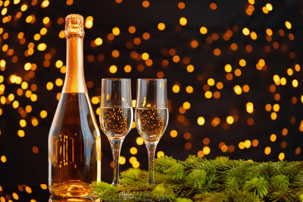 istock Champagne bottle and glasses on blurred lights background 1272558848