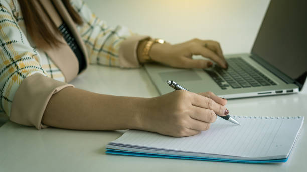 istock Work of girl with laptop computer, pen and notebook 1272558886
