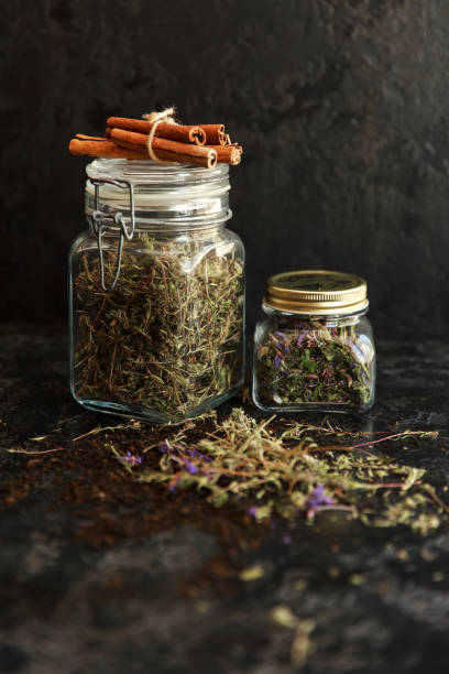 istock Jars of different leaf teas on dark background. 1272560847