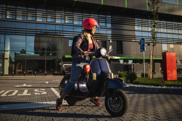 Beautiful young girl rides scooter