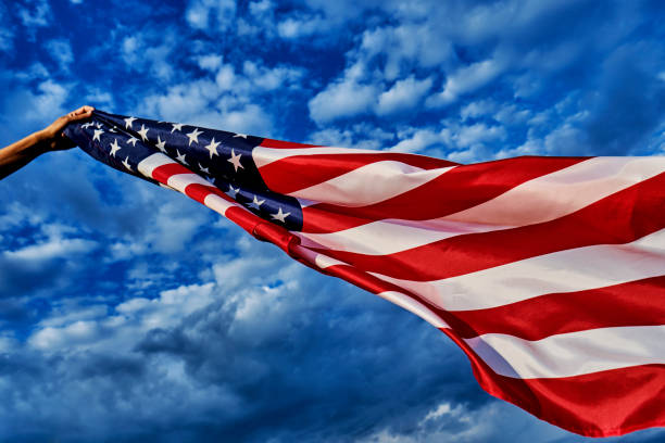 istock man waving an American flag on the wind 1272562050