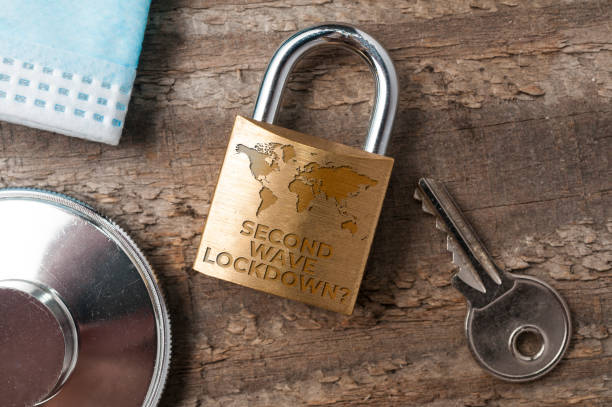 istock Covid-19 lockdown concept: a lock sorrounded by a key, a stethoscope and a surgical map with the question 