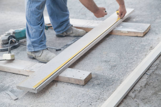 istock Tiler measures and cuts natural tiles. 1272563920