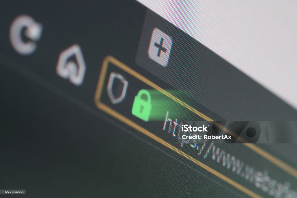 Dark web browser close-up on LCD screen with shallow focus on https padlock Dark web browser close-up on LCD screen with shallow focus, light shining through https padlock. Internet security, SSL certificate, cybersecurity, search engine and web browser concepts HTTPS Stock Photo