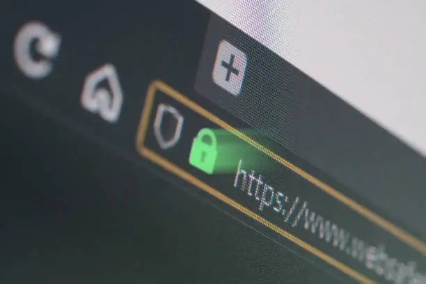 Photo of Dark web browser close-up on LCD screen with shallow focus on https padlock