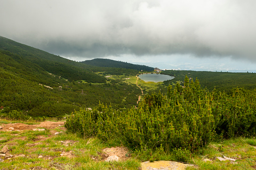 Dramatic sky over Bezbog hut and lake in Pirin mountain, Bulgaria, Europe.