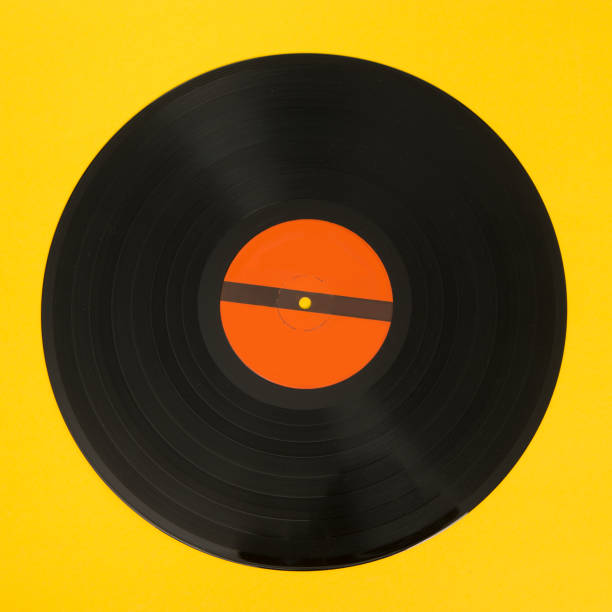 istock Black vinyl record on a yellow background 1272565204