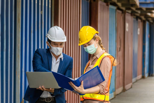istock industrial worker caucasian woman and asian engineer control worker checking cargo container at container cargo harbor, transport, industrial, logistic, transportation, import and export concept 1272565250