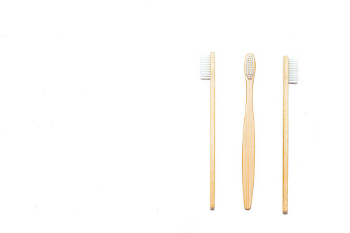 Bamboo toothbrush on an isolated background. Tooth cleaning. Article about choosing a toothbrush. Article about dental care. Bath accessories. Collection on vacation. Natural material. Eco-products. No plastic surgery. Concern for the environment. Copy space.