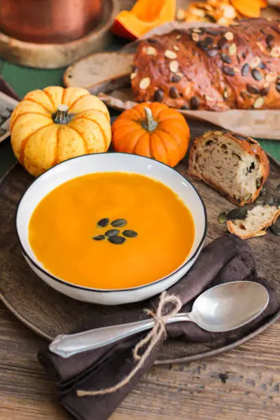 Photo of autumn pumpkin soup food styling in the kitchen