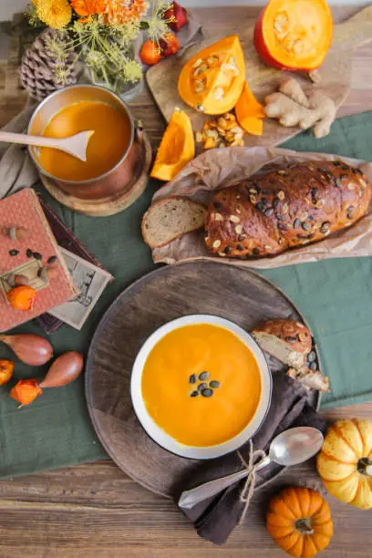 Photo of autumn pumpkin soup food styling in the kitchen