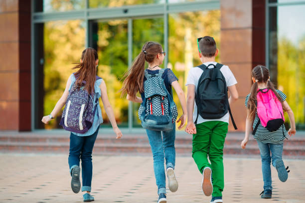 Group of kids going to school together. stock photo
