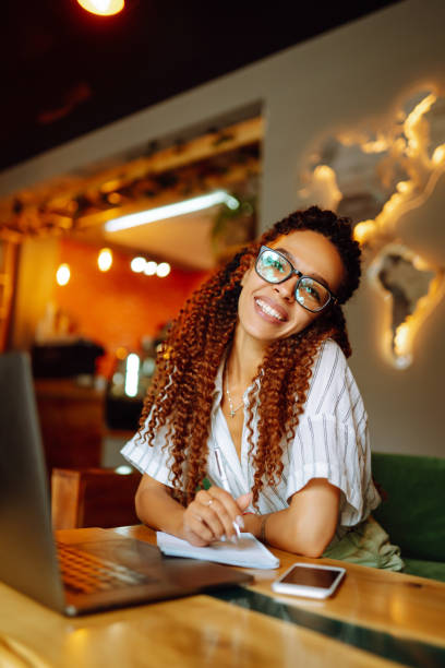 istock Young freelancer woman using laptop computer sitting at cafe table. 1272568118