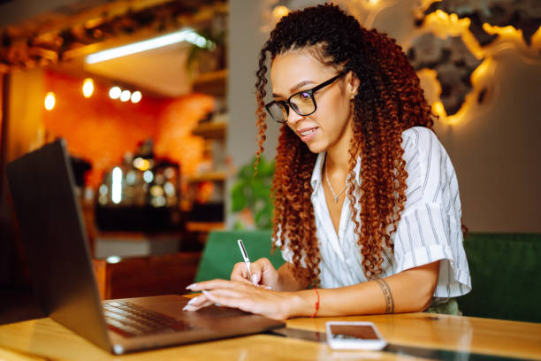 istock Young freelancer woman using laptop computer sitting at cafe table. 1272568125