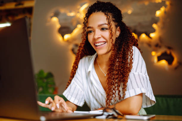 istock Young freelancer woman using laptop computer sitting at cafe table. 1272568142