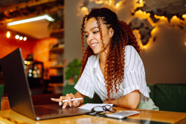 istock Young freelancer woman using laptop computer sitting at cafe table. 1272568166